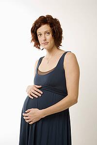 Pregnant woman with hands on belly 