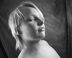 Male adolescent looking at viewer out of corner of eye