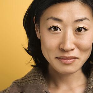Close up portrait of mid adult Asian woman.