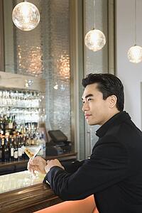 Man sitting at bar with drink