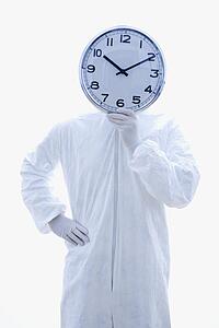 Biohazard suit holding clock in front of face