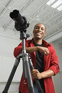 African American young male adult looking at viewer smiling.