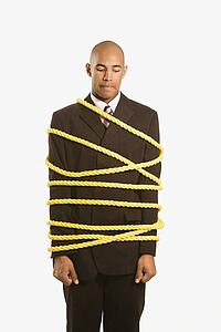 businessman wrapped in yellow rope
