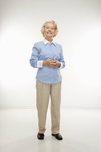 Woman standing with hands together 
