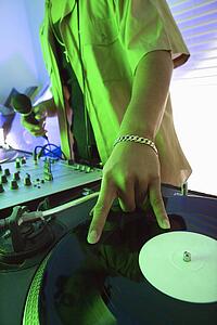 DJ's hand spinning vinyl record
