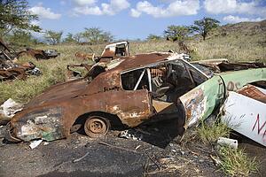 Old rusted car in junkyard