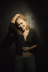 Woman with head down smiling