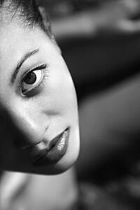 Close up of Filipino young woman looking at viewer.
