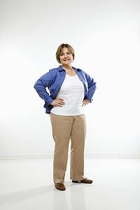 Woman standing with hands on hips 