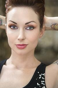Close up portrait of attractive tattooed woman.