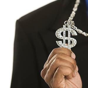 African American man wearing necklace with money sign.