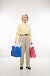 woman holding gift bags smiling 