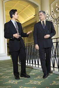 Adult businessmen in hotel.