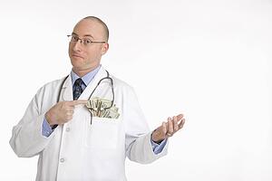 physician with cash hanging out of pocket