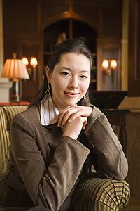 Businesswoman with chin resting on hands