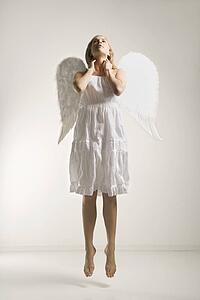 Angel in costume jumping in air