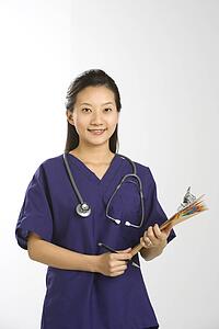Portrait of Asian Chinese mid-adult female doctor smiling and looking at viewer.