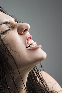 woman grimacing with eyes closed