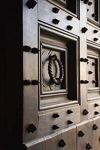 Wooden door with metal spikes and knocker