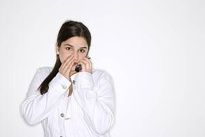 Whispering into cellphone standing 