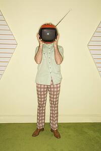 Man holding retro television in place of head
