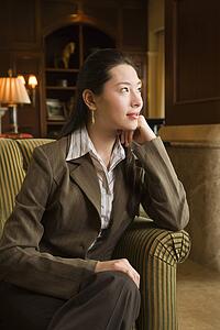 Businesswoman looking to side with head resting on hand