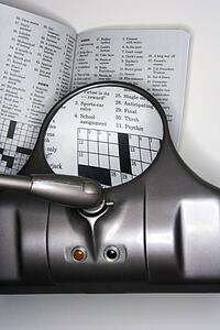 Vision magnifying glass used to view crossword puzzle