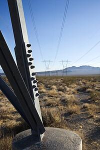 Electrical power lines in barren desert landscape