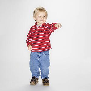 Boy standing and pointing against white background