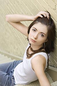 Redhead woman sitting on fire escape