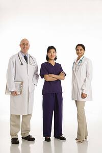 Caucasian mid adult male physician with Asian and Indian women doctors.