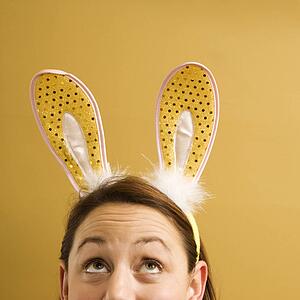Woman wearing rabbit ears and looking up