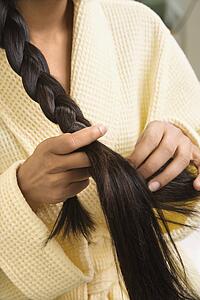 Woman braiding hair