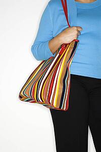 Mature adult woman holding big purse