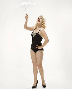 Attractive woman wearing retro swimsuit in pinup pose with umbrella