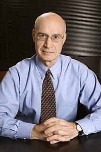 Caucasian middle-aged businessman sitting at desk in office.