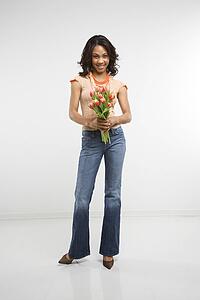 Woman holding bouquet of tulips smiling