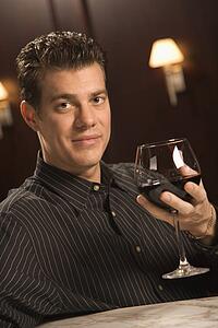 Man holding glass of red wine