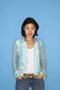 Waist up portrait of pretty mid adult woman on blue background