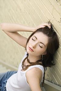 Portrait of attractive young redhead woman sitting on steps