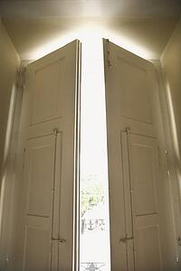 Doors opening with sunlight streaming in