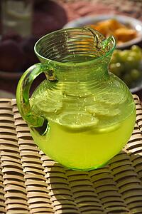 Pitcher of lemonade with sliced lemons.