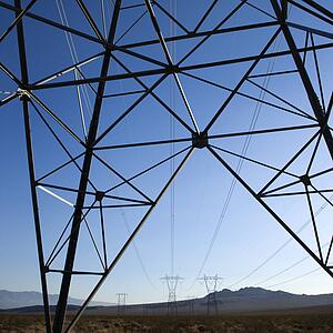 Electrical power lines in barren desert landscape