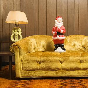 Santa clause figurine on retro style couch