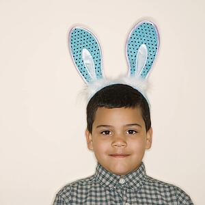 Portrait of boy wearing bunny ears looking at viewer