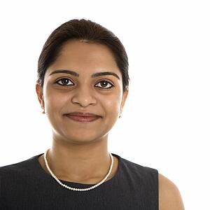 Head and shoulder portrait of pretty mid adult Indian woman.