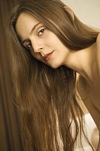 Portrait of woman with long hair looking at viewer.