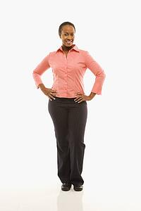 Portrait of woman standing smiling against white background