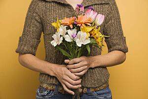 Holding bouquet of flowers