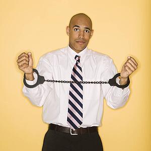 Businessman wearing handcuffs